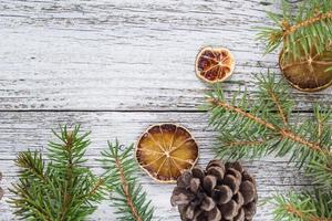 Christmas fir branches with cones and dry lemon slice photo