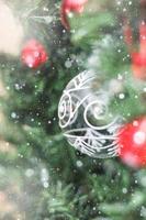 Christmas decorations on tree under snow photo