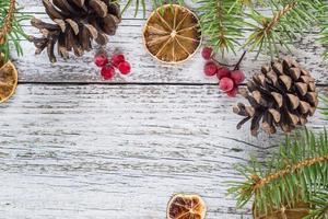 Christmas branches with cones viburnum berries and dry lemon slice photo