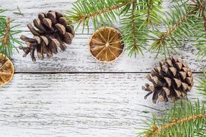 Christmas fir branches with cones and dry lemon slice photo