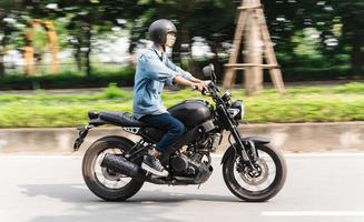 Image of Asian man driving on the street photo