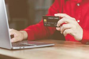 shopping online and payment concept, male hand holding credit card To conduct financial transactions, payment online, order online.via the internet link to the world contact in many countries photo