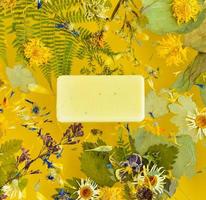 Dried plantain and flowers laid out on a yellow background, levitation. Preparation of homemade soap. Eco-friendly. Flat lay. photo