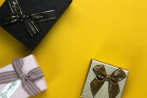 Three Gift Boxes are isolated on yellow background. photo