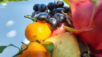 Close up, tropical fruit grapes, oranges, dragon fruit, pears and apples on a white background 02 photo