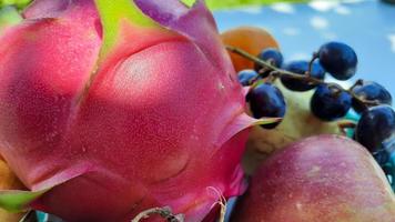 Close up, tropical fruit grapes, oranges, dragon fruit, pears and apples on a white background 01 photo