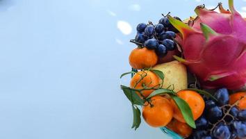 Flat lay, Tropical Dragon Fruit Oranges, pears, grapes on white background 05 photo