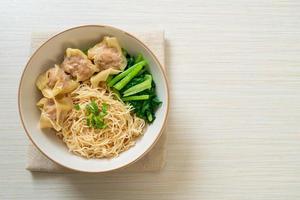 dried egg noodles with pork wonton or pork dumplings without soup photo