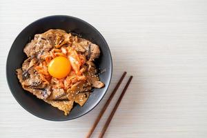 pork bulgogi rice bowl with kimchi and Korean pickled egg photo