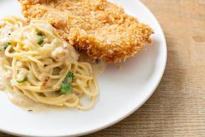 spaghetti pasta white cream sauce with fried fish photo