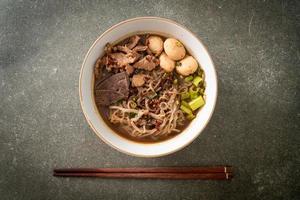 Thai noodle with pork, stewed pork, meatball and pork liver in blood soup photo