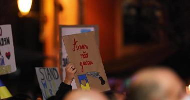 Love Not War In Portuguese Placard With Illustration Of Gun And Ukrainian Flag With Heart. Prayer For Peace In Ukraine Vigil At Night In Leiria, Portugal. static video