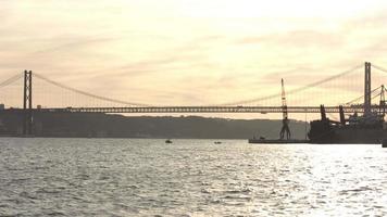 View to the 25Th April Bridge Tejo's River with the road traffic at the sunset. Sunset at the Tejo's River at the end of the day video