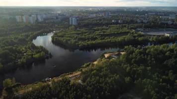 Top view of the river with turns of meanders and green forests in bright sunlight. Creek in the park among the trees. video
