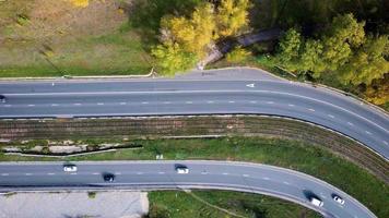 bird's-eye view of the road with an autumn forest and a road slot. video