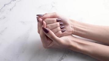 Hands of a young woman with white manicure on nails video