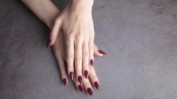 Hands of a young woman with white manicure on nails video