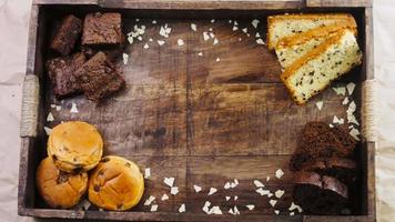 Different kinds of cakes arranged on a wooden tray video