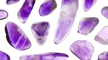 Amethyst rare jewel stones texture on white light isolated background. Moving right seamless loop backdrop. video