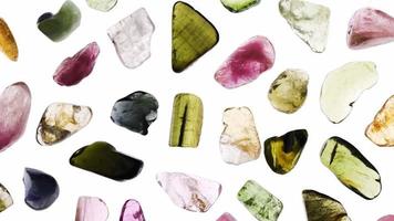 Tourmaline rare jewel stones texture on white light isolated background. Moving right seamless loop backdrop. video