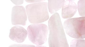 Morganite heap jewel stones texture on white light isolated background. Moving right seamless loop backdrop. video