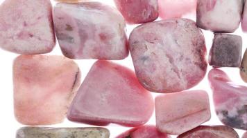 Rhodochrosite heap jewel stones filled texture on white light background. Moving right seamless loop backdrop. video