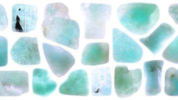 Isolated amazonite gem stone texture. Rare mineral pebbles background. Moving right seamless loop backdrop. video