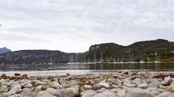 Aerial shot of the Garda Lake in Italy with a mountain in the background during winter video