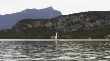 A panorama of a large lake with a motorboat sailing across the calm water video