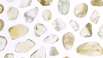 Citrine rare jewel stones texture on white light isolated background. Moving right seamless loop backdrop. video