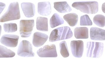 Isolated blue lace agate gem stone texture. Rare mineral pebbles background. Moving right seamless loop backdrop. video