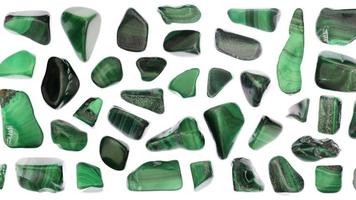 Malachite jewel stones set texture on white light background. Moving right seamless loop backdrop. video