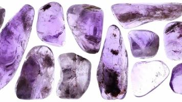 Isolated rutilated amethyst gemstones set texture. Moving right seamless loop backdrop. video