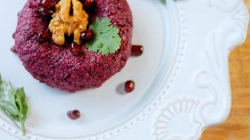 The girl tastes pkhali. Pkhali traditional Georgian food. Beetroot is used for the purple color. Walnut is used for decoration video