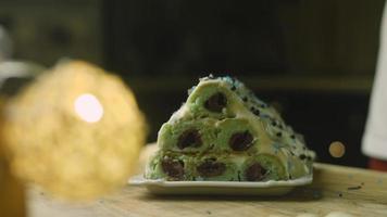 Cake with green dough, sour cherries and sour cream. It also has food ornament and the red star cake video