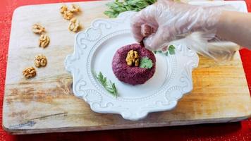 Pkhali traditional Georgian food. Beetroot is used for the purple color. Walnut is used for decoration video