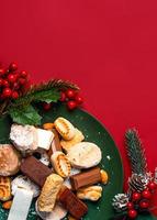 Top view of Nougat christmas sweet,mantecados and polvorones with christmas ornaments on a plate. Assortment of christmas sweets typical in Spain photo