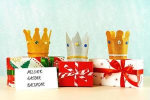 Three crowns of the three wise men with Christmas gift boxes. Concept for Dia de Reyes Magos day. Three Wise Men photo