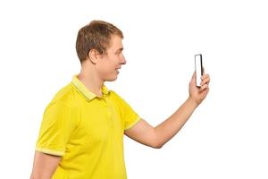 Funny guy in yellow T-shirt taking photos using smartphone, guy with mobile phone, white mockup