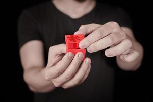 Man give a gift in red gift box on St. Valentine day photo