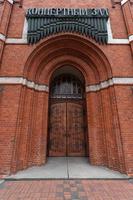 Catholic church of Holy Family in Russia, Kaliningrad city. Neogothic red brick building style. Inscription Concert Hall. photo