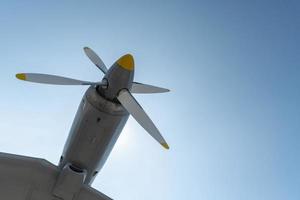 Airplane propeller of military aircraft, copy space. Blue sky sunny background. photo