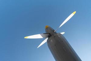 Airplane propeller of military aircraft, copy space. Blue sky sunny background. photo