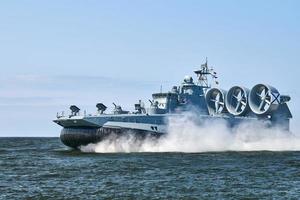 Landing Craft Air Cushion hovercraft flying above water, air cushion sailing splashing sea water photo