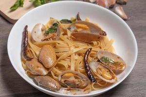 Pasta stir-fried with clams with basil and chili photo