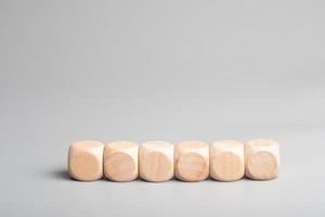 Empty wooden dice stacked on gray background photo