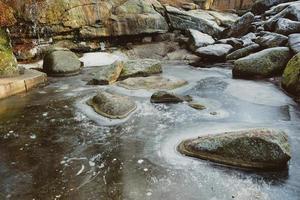 huge round frozen stones  in winter park photo