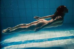 athletic sport woman underwater in the swimming pool photo
