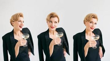 three mature stylish elegant women twins in tuxedo with glass of sparkling wine. Party, celebration, anti age concept