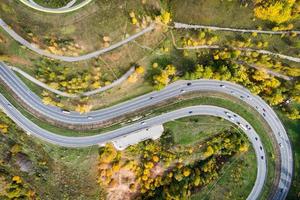 bird's-eye view of the road with an autumn forest and a road slot. photo